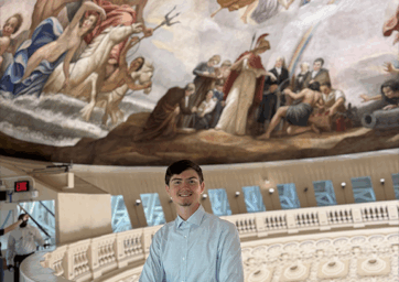 Flynn Condit stands on the upper level of the US Capitol Rotunda.