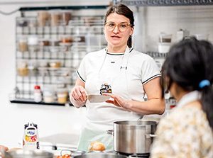 MSU Denver Registered Dietitian Natalie Nowak leads a demo in the Cooking with Purpose class at the Hospitality Learning Center.