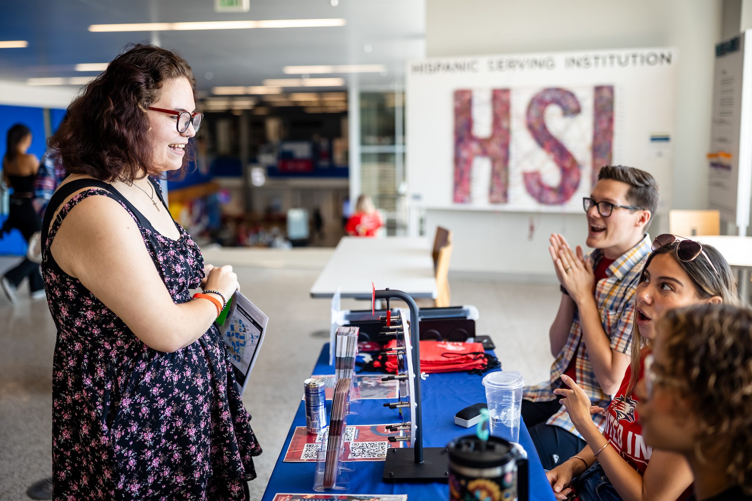 Student consulting staff members in a office setting