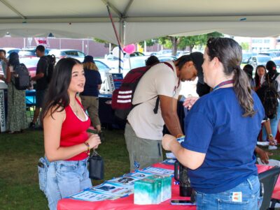 Wendy Walker talking with a student at the CBUS Welcome Back Bash