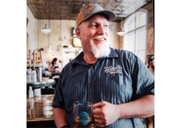 Chris Thibodeau holding a beer mug