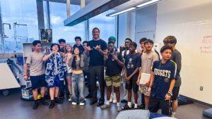 A group of high school kids standing with Aaron Gordon from the Denver Nuggets