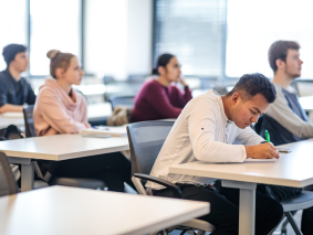 Three students sitting in a classroom