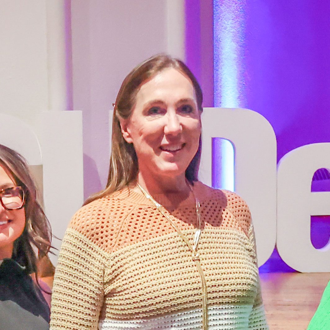 Shelly Davis standing in front of an MSU Denver sign