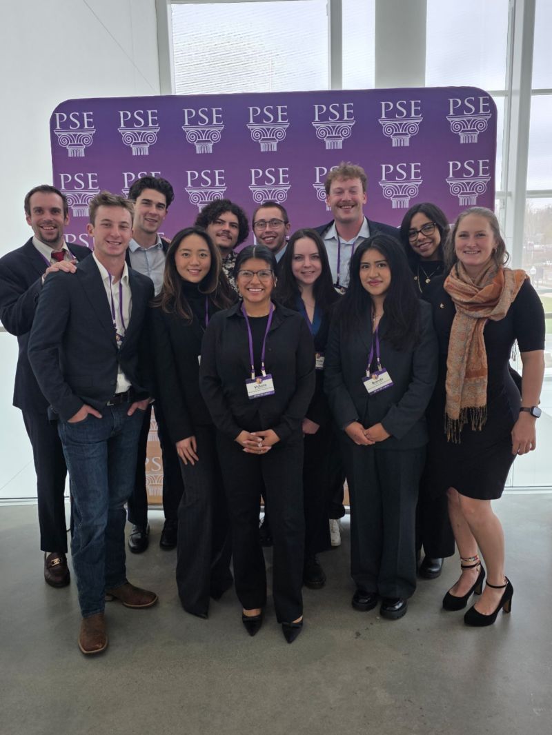Twelve Pi Sigma Epsilon Eta Upsilon members at the 2025 Fall Regional Conference with a PSE background in the back