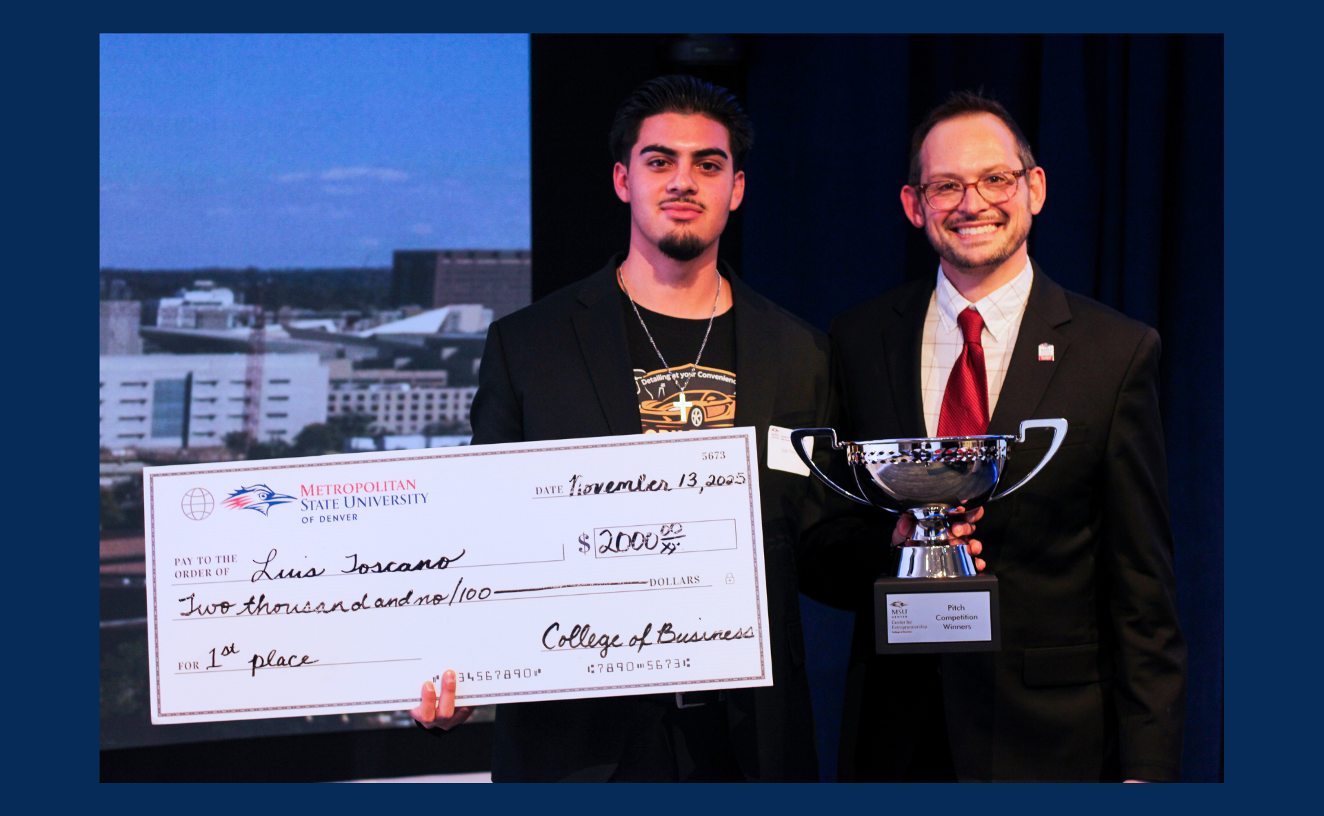 A photo of a student holding a $2,000 check with Adam Melnick