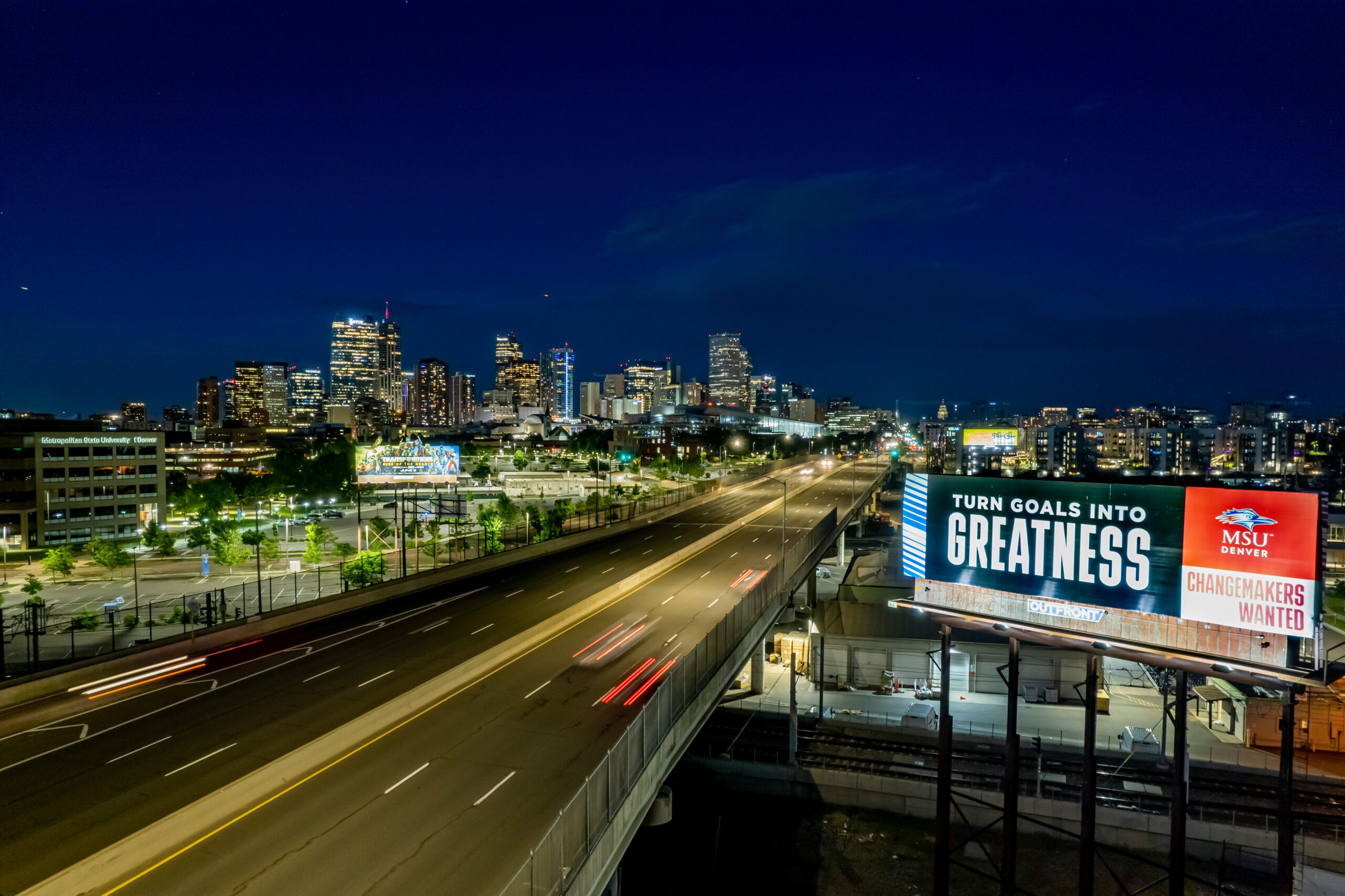 A photo of the Denver skyline with an MSU Denver Billboard in the foreground