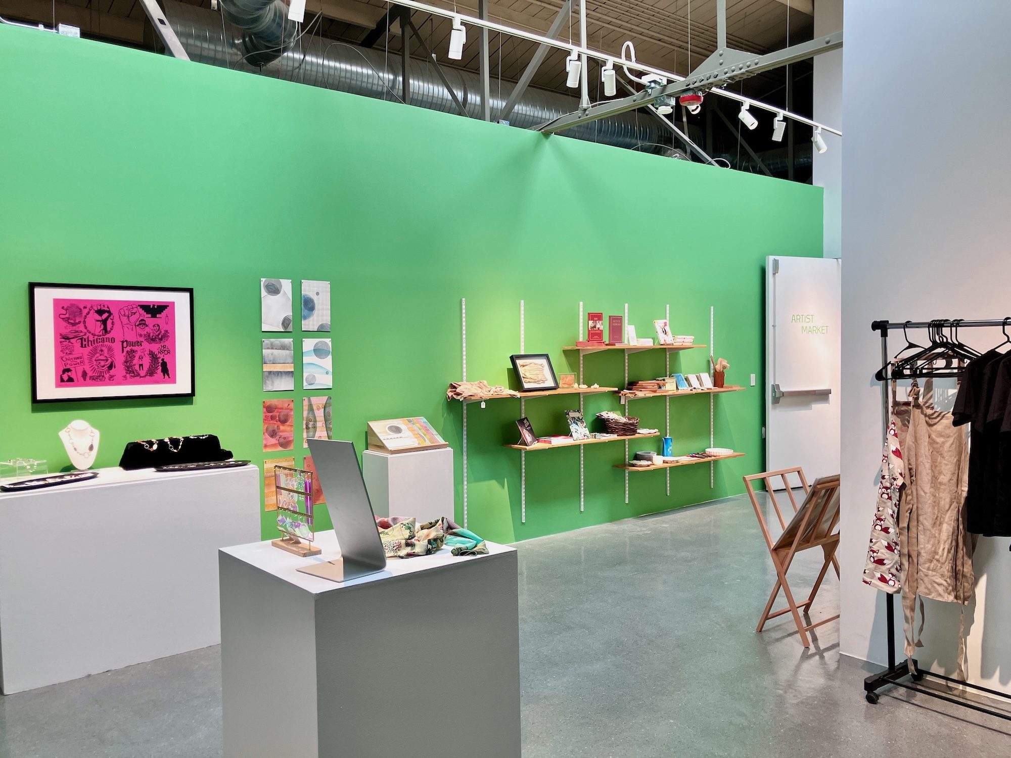 A gallery at CVA is set up like a shop with objects displayed on pedestals, wall shelves, and racks.