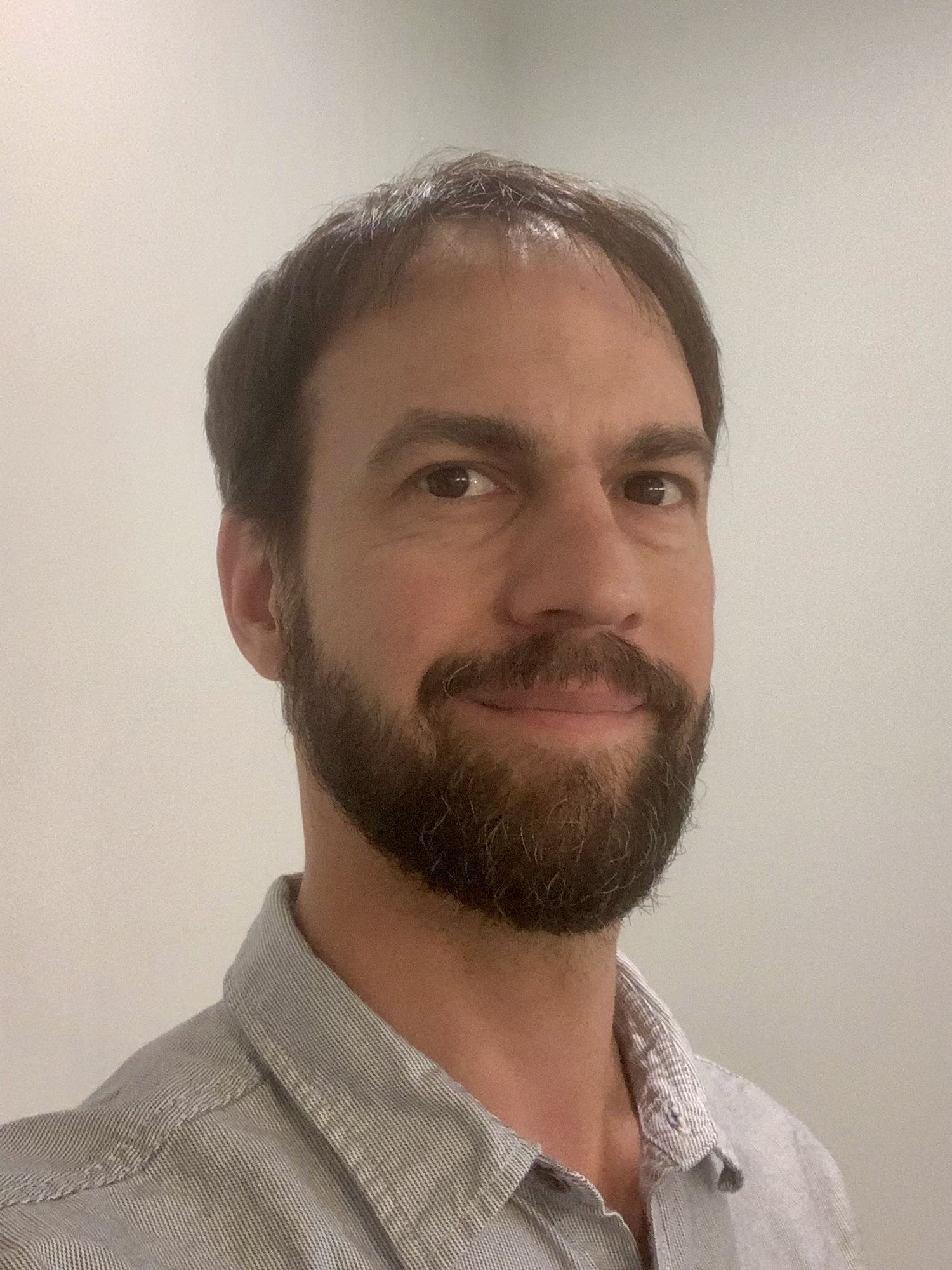 Instructor Karlan Schneider in a grey collared shirt.