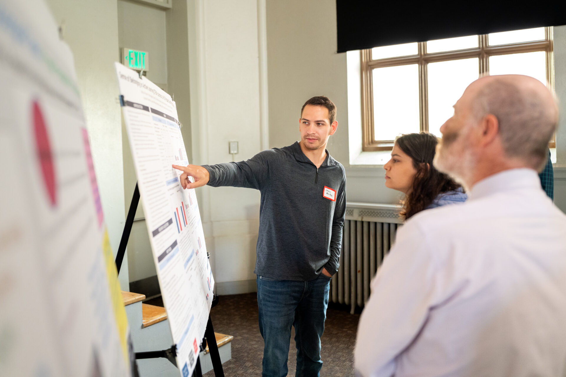 Student presenting poster paper at a conference.