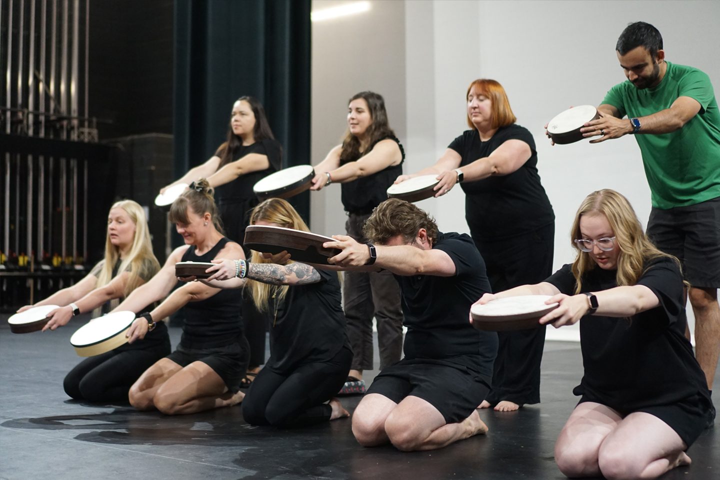 musicians holding out hand drums