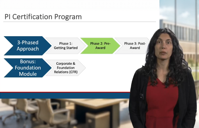 Emily Ragan stands in front of a slide that describes the phases of the PI Certification Program