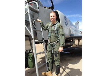 Jim Balutkowski in his military fatigues standing outside of an airplane