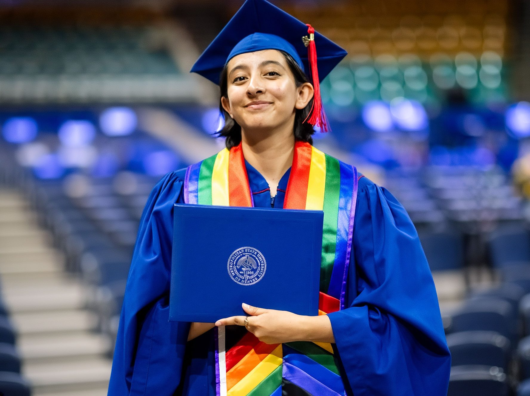 MSU Denver Graduate holding degree during commencement