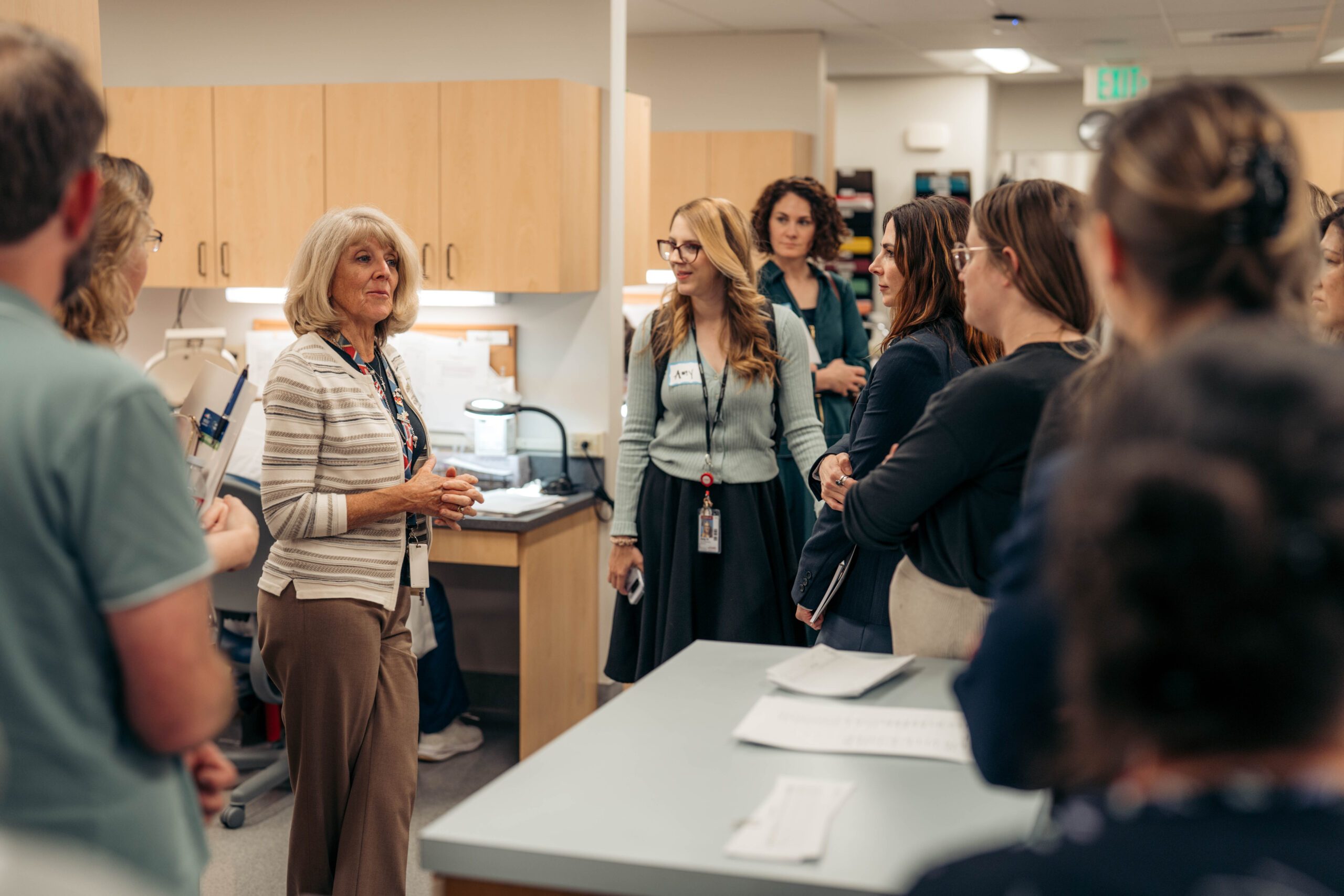 A staff member shares information in a laboratory to a crowd of attendees.