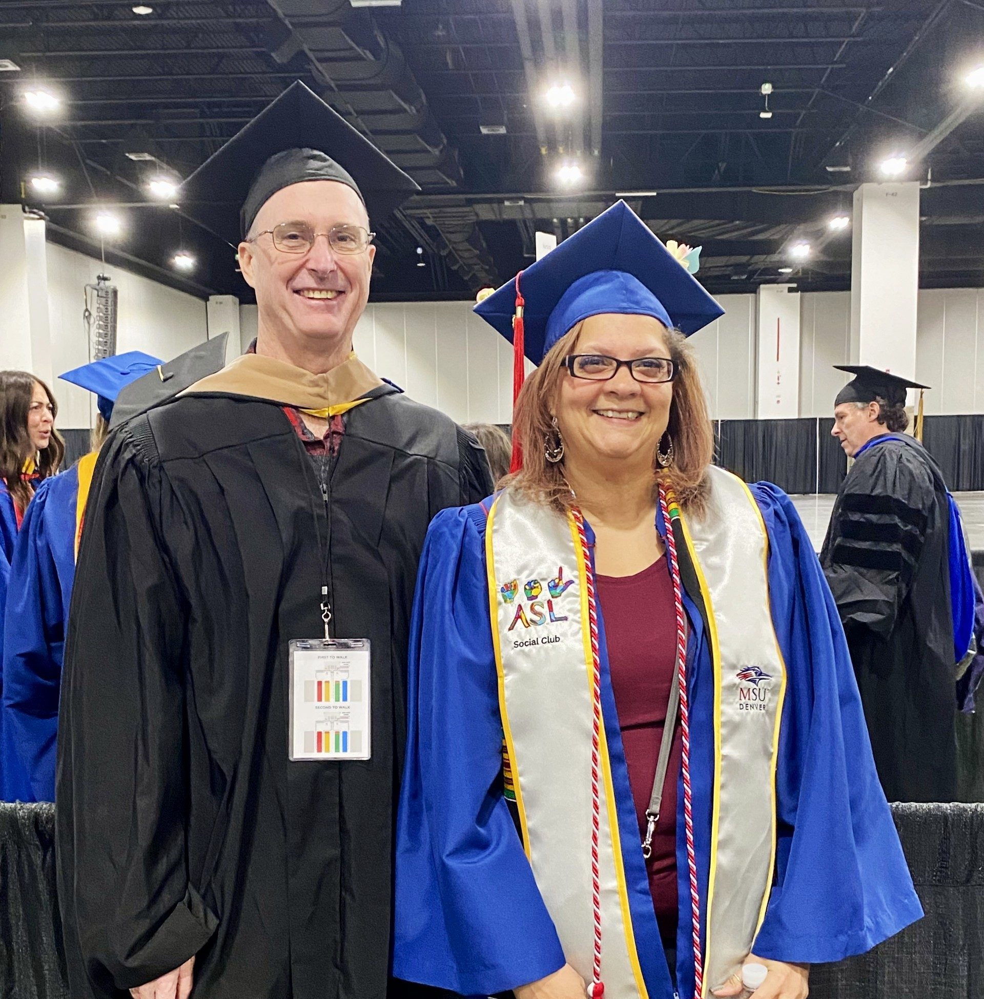Fall '25 Commencement Ceremony - Accounting faculty Jim and accounting grad TJ smiling in regalia