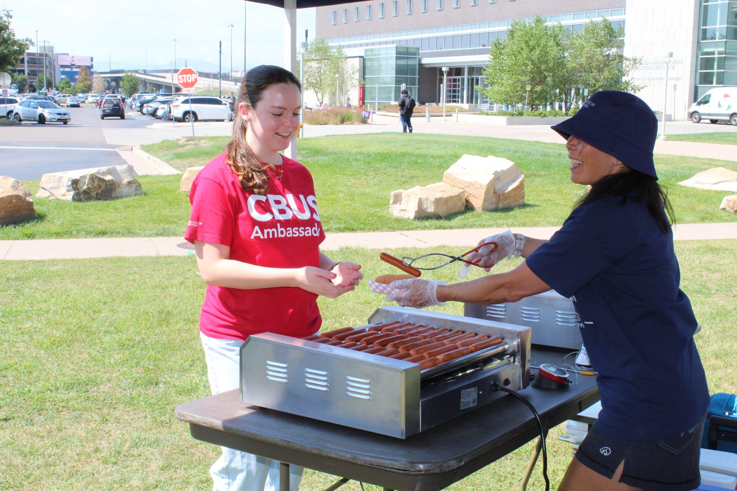 ambassador with Laurie Nakauchi giving out hotdogs