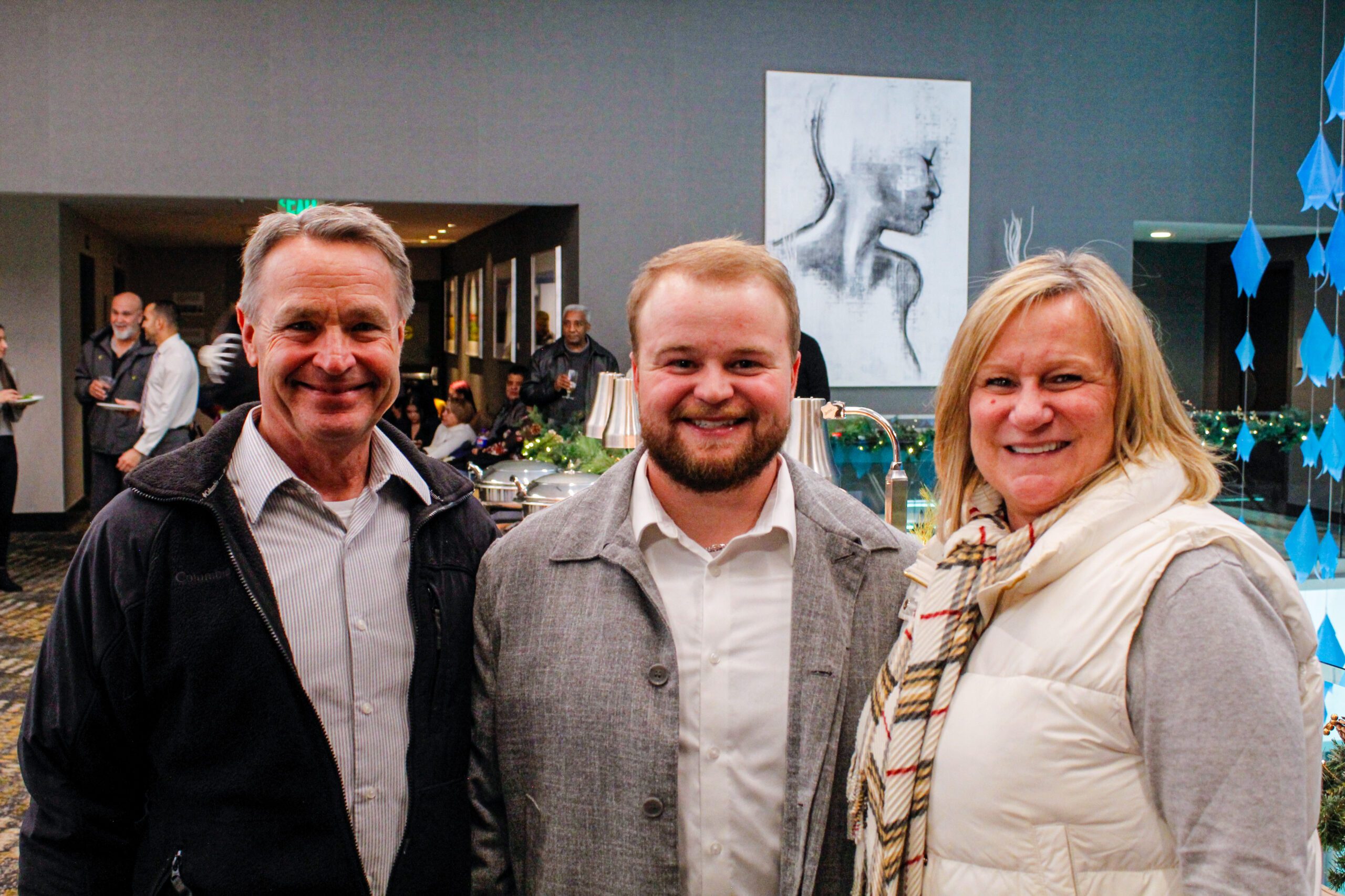 Fall '25 MBA & MPAcc Hooding Celebration - MPAcc grad, Joe, smiling with family