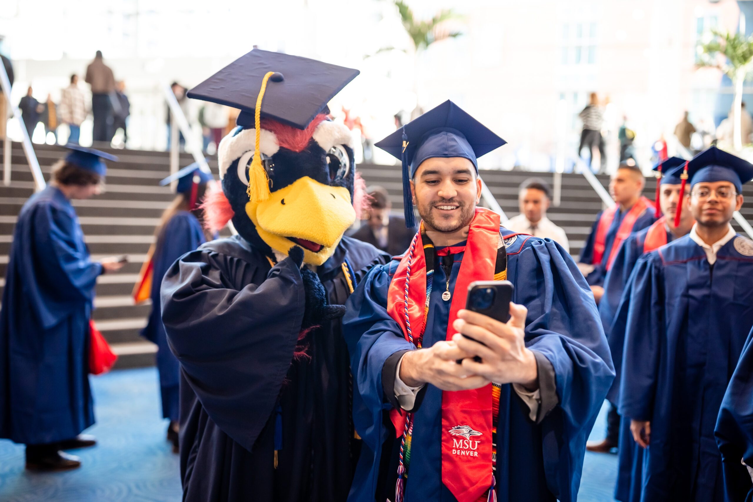 Fall '25 Commencement Ceremony - MPAcc grad, Kevin, takes a photo with Rowdy while in line to check-in at event