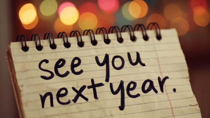 A notepad is in focus in front of various colored lights with text that reads 