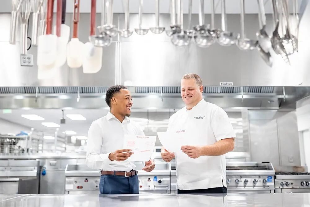 two MSU Denver Hospitality Leadership students laughing and talking