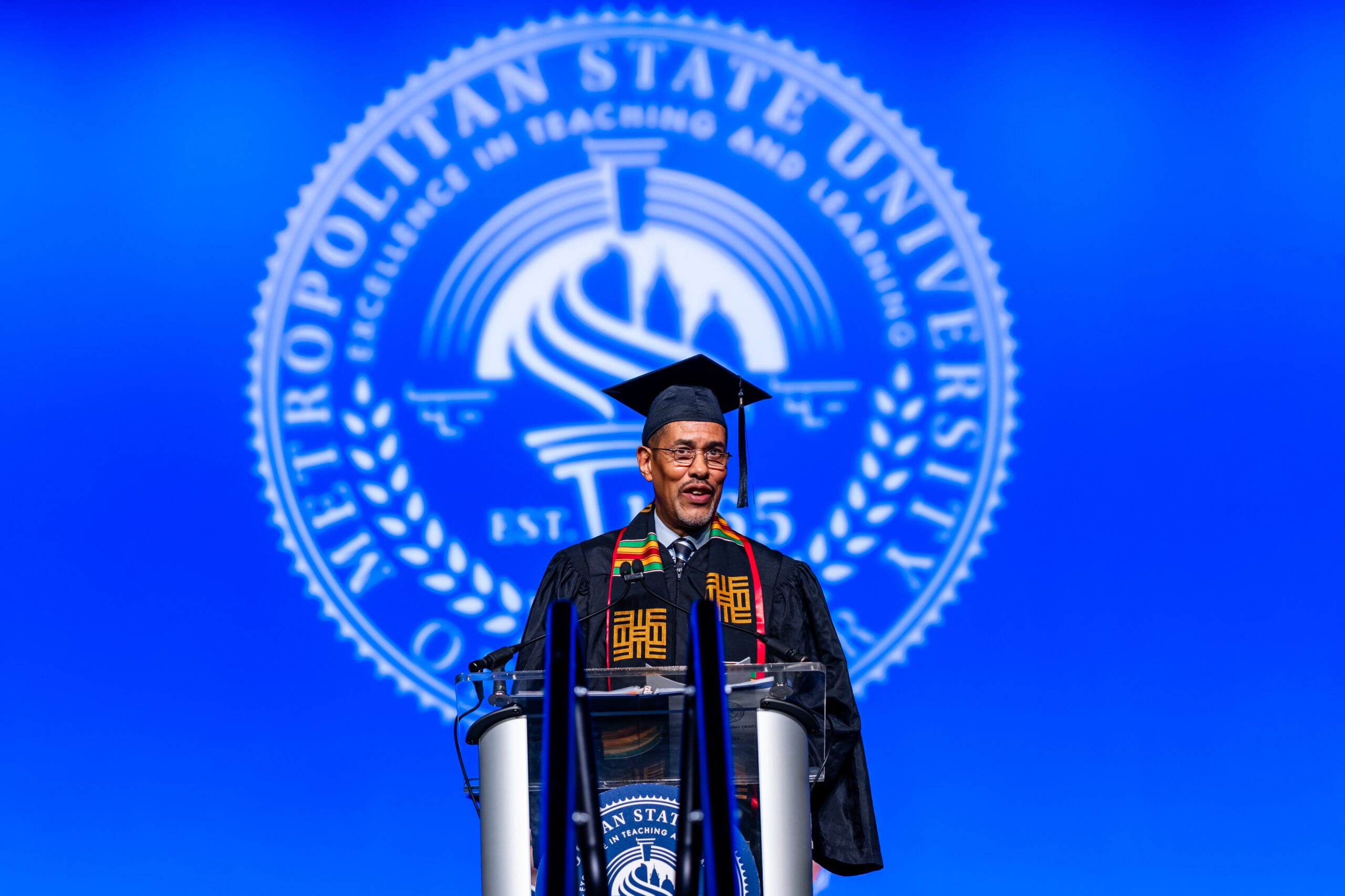 Fall '25 Commencement Ceremony - Chuck Moss, accounting alum and keynote speaker, at the podium on stage