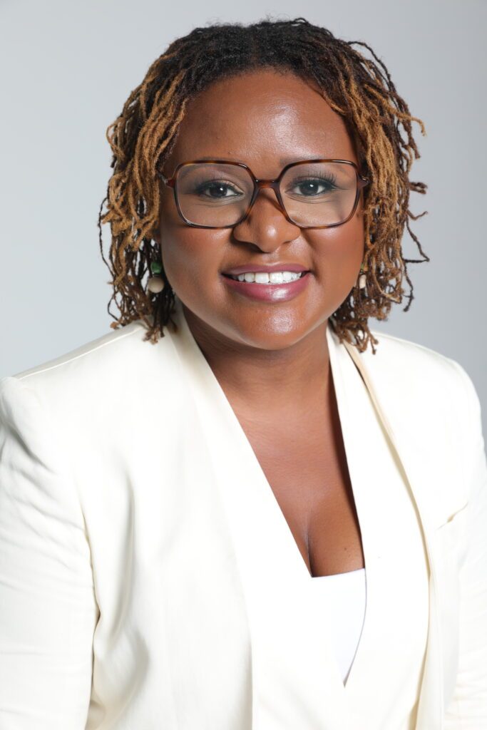 Park Cannon Black woman in white suit wearing glasses