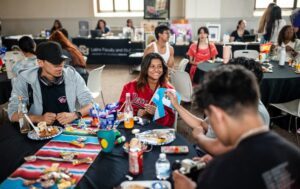 Students at table eating.