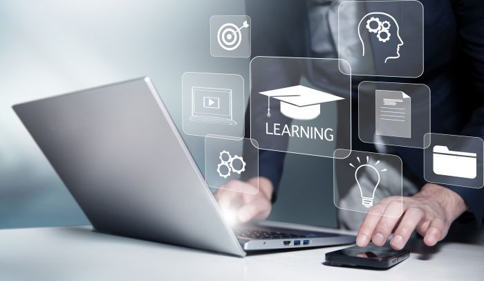 Hands type on a laptop and on a phone while abstract images of apps pop up