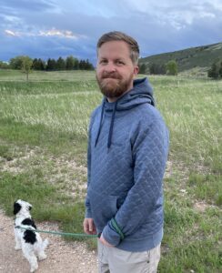 Erik Eckhoff standing on a gravel path with a grassy field in the background