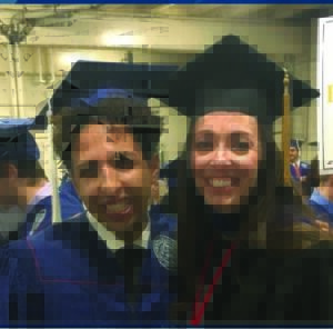 Two graduates with caps on