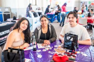 3 students sitting at a table.