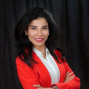 Headshot of Hediyeh Arasteh in a red suit. 