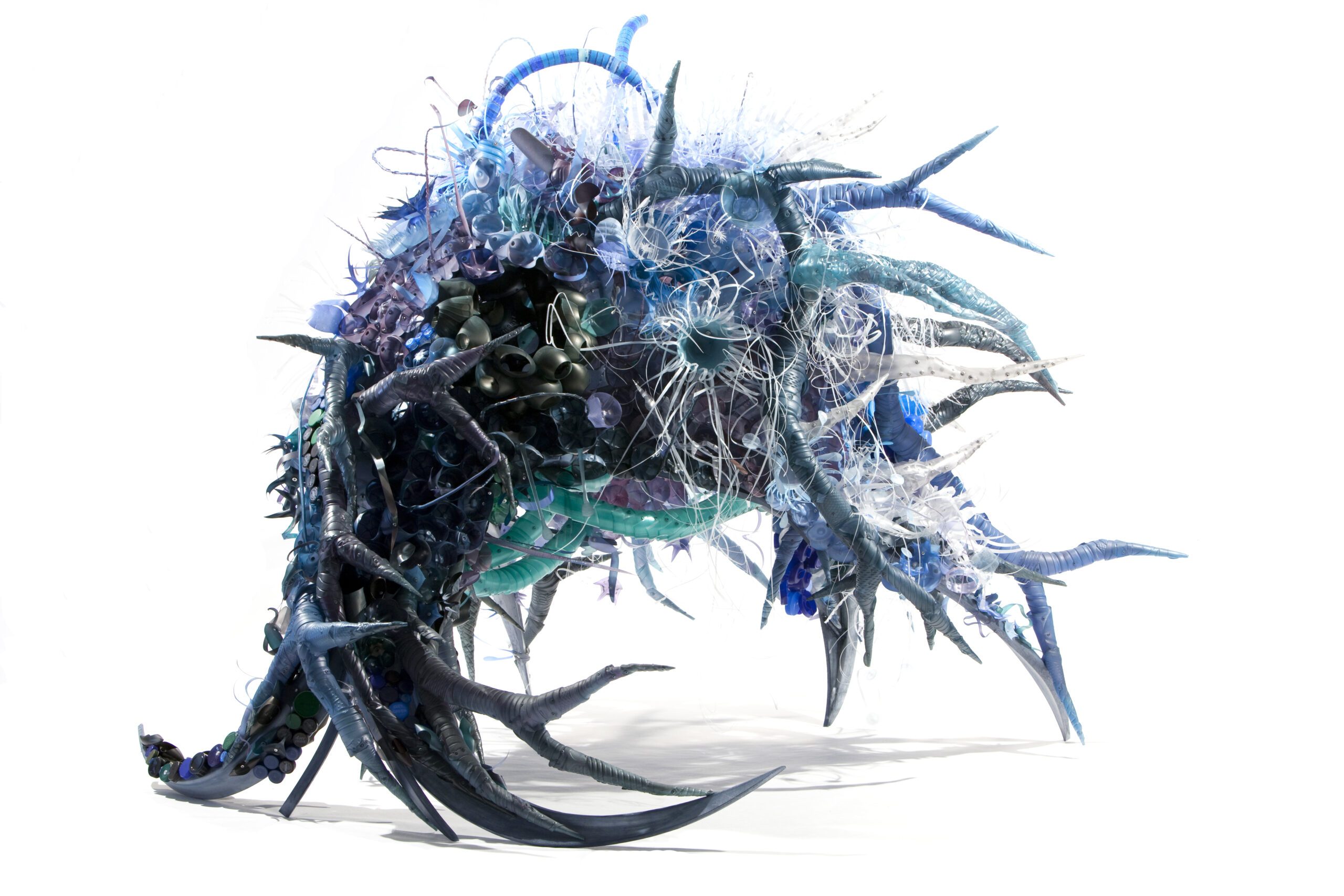 Abstract sculpture with spiky, tentacle-like forms in shades of blue, white, and black.
