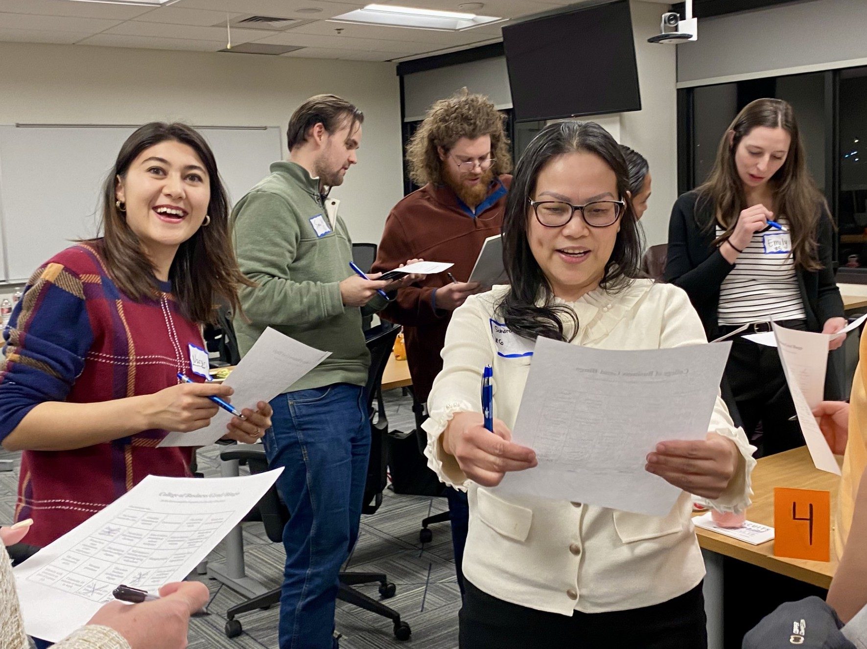 MPAcc Spring '26 Orientation - 5 students in the midst of playing the bingo networking activity