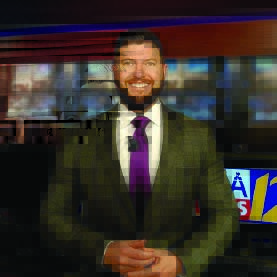 Man in a suit and tie smiles for the camera