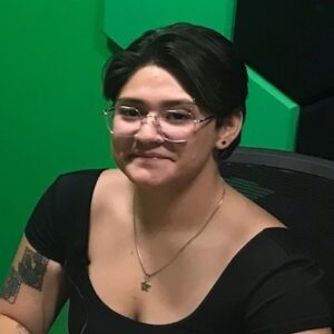 A person with short dark hair and glasses