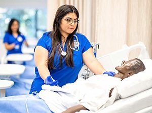 MSU Denver Nursing student Marisa Schreiner simulates giving a mannequin an injection at the Simulation and Skills Laboratory.