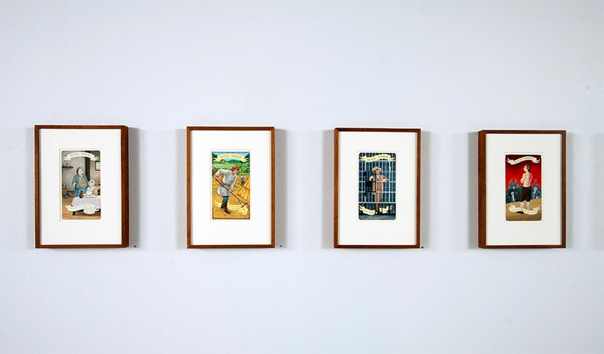 Four framed colorful illustrations on a white wall.