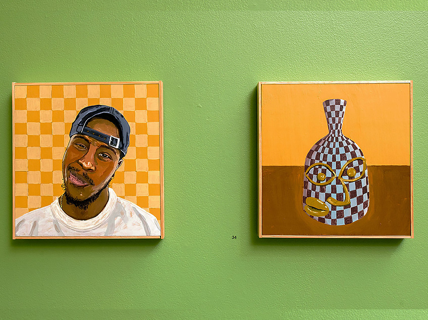 Two paintings on a light green wall; a portrait of a man with a checkerboard background, and a checkered vase with facial features.