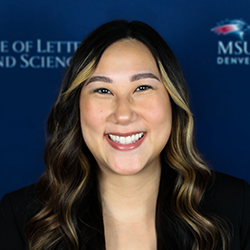A woman with long, dark hair wearing a black blazer