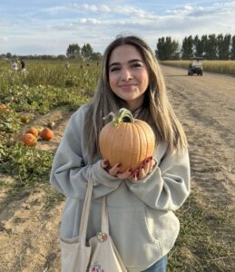 Photo of Isabella with a pumpkin