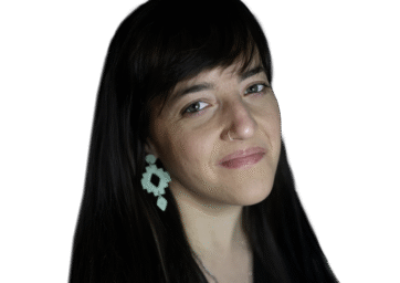 Woman with black long hair and bangs with light blue earrings