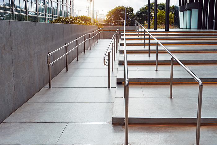 An image of a set of stairs next to a wheelchair ramp