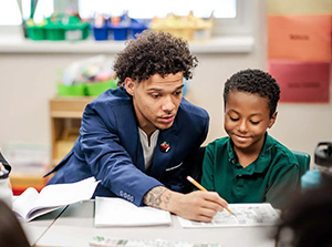 MSU Denver's Jordan Puch works with a student at Green Valley Elementary School.