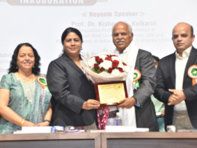 Dr. Kishore Kulkarni represented MSU Denver abroad at two international conferences holding an award and flowers.