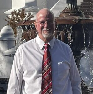 Man in white shirt and red striped tie