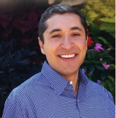 Picture of a man smiling with a garden in the background
