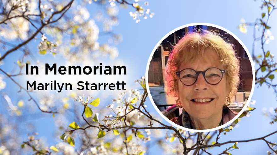 A memorial graphic featuring a circular portrait of Marilyn Starrett on the right, set against a soft background of tree branches with white blossoms and a bright blue sky. The text ‘In Memoriam Marilyn Starrett’ appears on the left in bold black lettering.