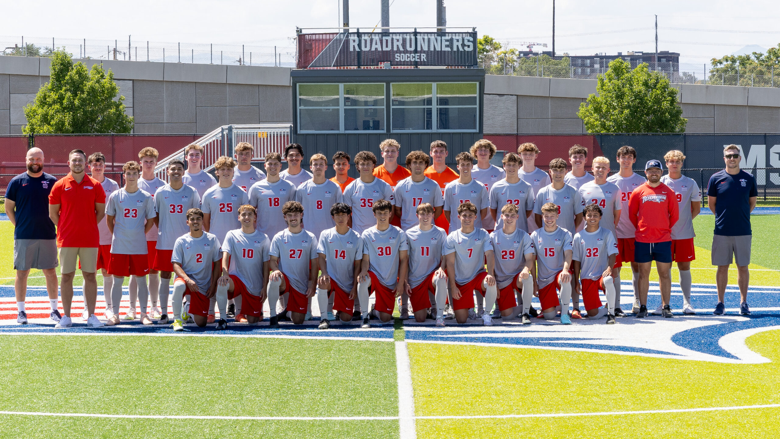 Men's soccer team picture in gray and red uniforms